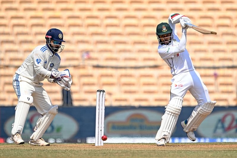 Bangladesh's Mehidy Hasan Miraz (R) plays a shot as India's wicketkeeper Rishabh Pant watches during the second day of the first Test cricket match between India and Bangladesh at the MA Chidambaram Stadium in Chennai on 20 September, 2024.