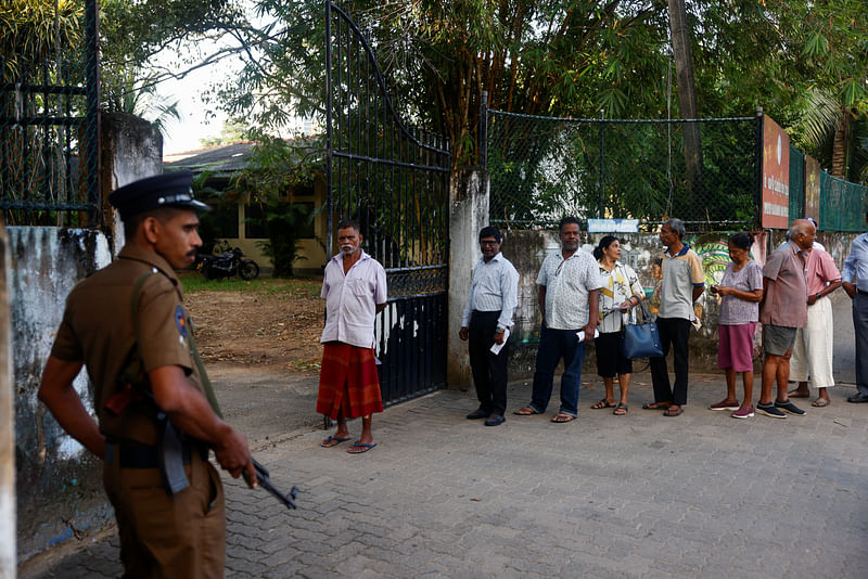 People stand in queue outside a polling station on the day of the presidential election in Colombo, Sri Lanka, 21 September 2024.