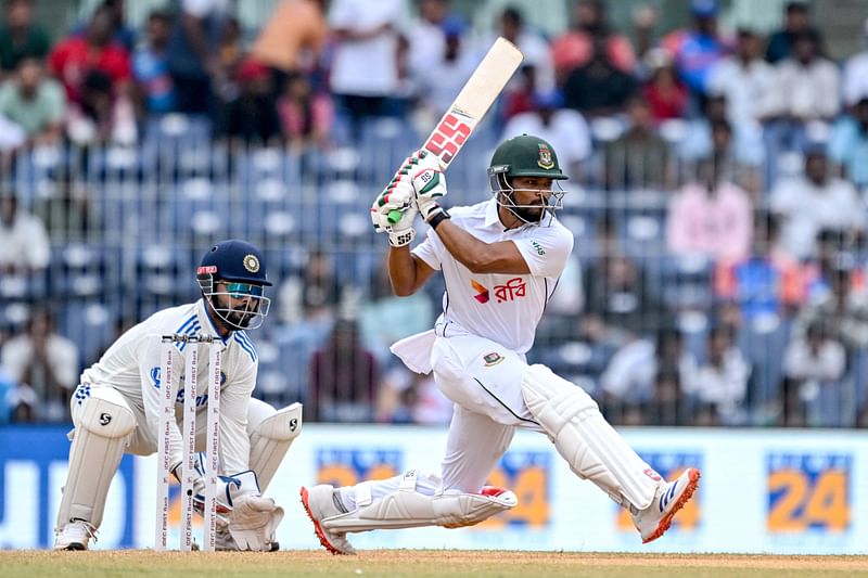 Bangladesh's captain Najmul Hossain Shanto (R) plays a shot as India's wicketkeeper Rishabh Pant watches during the third day of the first Test cricket match between India and Bangladesh at the M.A. Chidambaram Stadium in Chennai on 21 September, 2024.