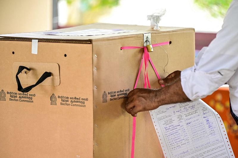 An election official seals a ballot box at the end of voting in Sri Lanka's presidential election at a polling station in Colombo on 21 September, 2024.