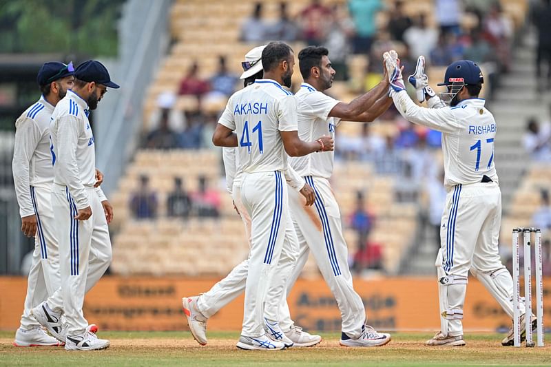 India's Ravichandran Ashwin (2R) celebrates with teammates after taking the wicket of Bangladesh's Shakib Al Hasan during the fourth day of the first Test cricket match between India and Bangladesh at the MA Chidambaram Stadium in Chennai on 22 September, 2024.