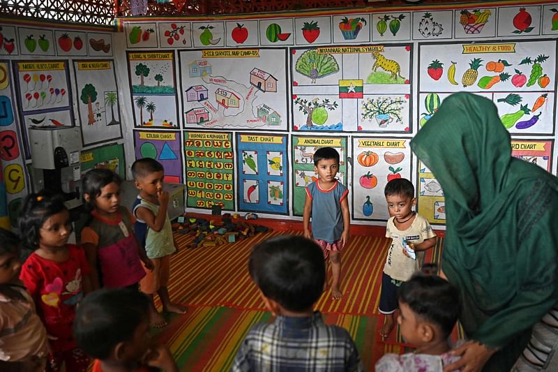 In this photo taken on 12 September 2024, Shonjida, a Rohingya woman teaches at a school in a refugee camp in Ukhia. Rohingya refugee Shonjida has endured years of boredom, misery and violence in Bangladesh -- but last month's overthrow of autocratic ex-premier Sheikh Hasina has given her fresh hope for the future.