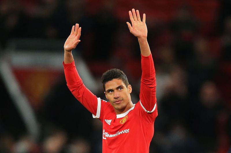 Manchester United's French defender Raphael Varane gestures to supporters on the pitch after the English Premier League football match between Manchester United and Tottenham Hotspur at Old Trafford in Manchester, north west England, on 12 March, 2022.