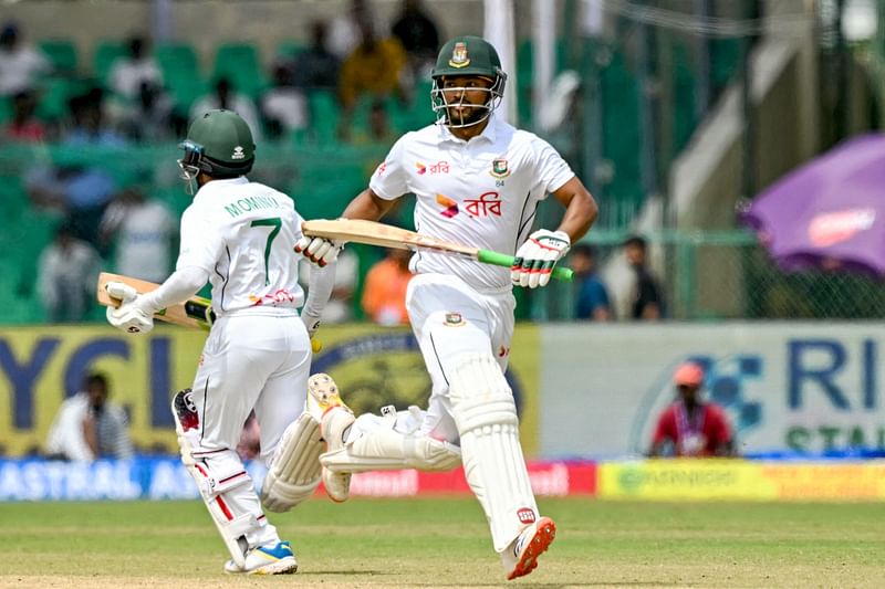 Bangladesh’s captain Najmul Hossain Shanto (R) and Mominul Haque run between the wickets during the first day of the second Test cricket match between India and Bangladesh at the Green Park Cricket Stadium in Kanpur on 27 September 2024