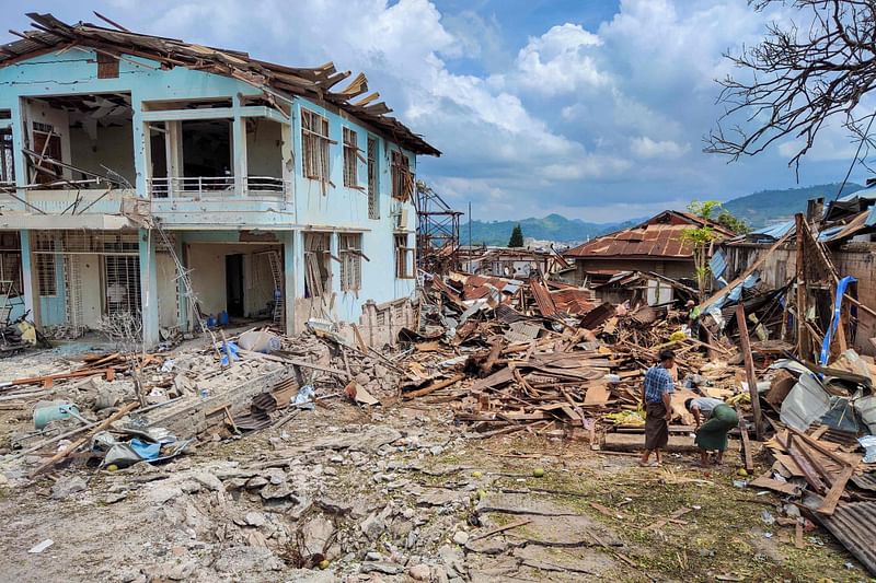 People clean up the debris of destroyed and damaged buildings in the aftermath of bombardments carried out by Myanmar's military in Lashio in Myanmar's northern Shan State on September 24, 2024