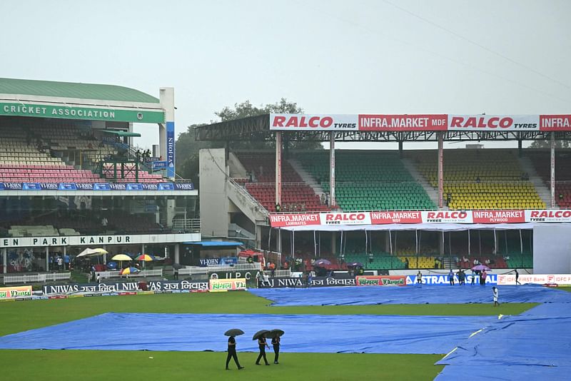 Groundstaff inspect the field as rain delays the start of the second day play of the second Test cricket match between India and Bangladesh at the Green Park Cricket Stadium in Kanpur on 28 September, 2024.