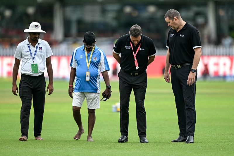 Match officials inspect the field before the start of the third day play of the second Test cricket match between India and Bangladesh at the Green Park Cricket Stadium in Kanpur on 29 September 2024