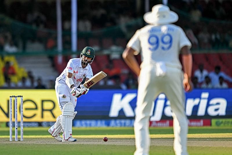 Bangladesh’s Shadman Islam (L) watches the ball after playing a shot during the fourth day of the second Test cricket match between India and Bangladesh at the Green Park Cricket Stadium in Kanpur on 30 September 2024