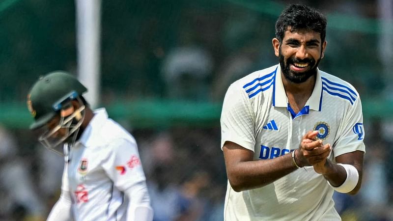 India’s Jasprit Bumrah (R) celebrates after taking the wicket of Bangladesh’s Mushfiqur Rahim (L) during the fifth and final day of the second Test cricket match between India and Bangladesh at the Green Park Cricket Stadium in Kanpur on 1 October 2024