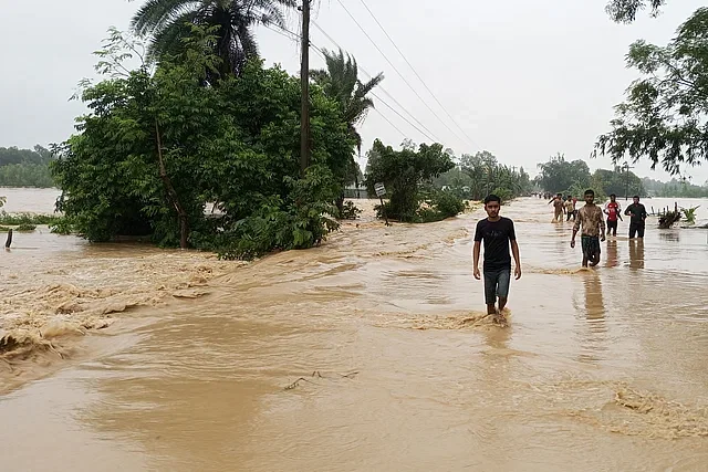 Water flows over the Nalitabari-Nakugaon road in Sherpur in the afternoon on 4 October, 2024.