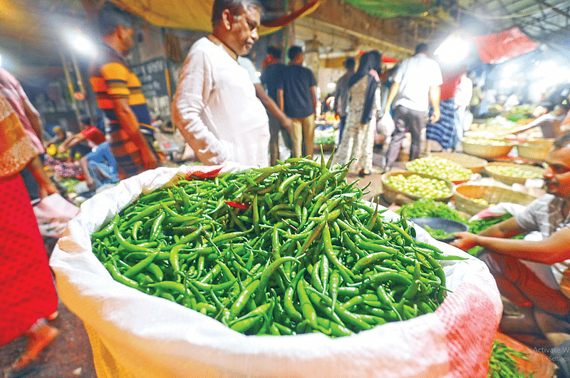 Photo shows green chillies at a vegetables shop.