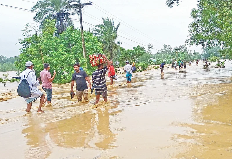 Heavy rains and water flowing down the hills have inundated the roads. Photo taken in Hatipagar area on​​Nalitabari-Nakugaon land port road in Sherpur.