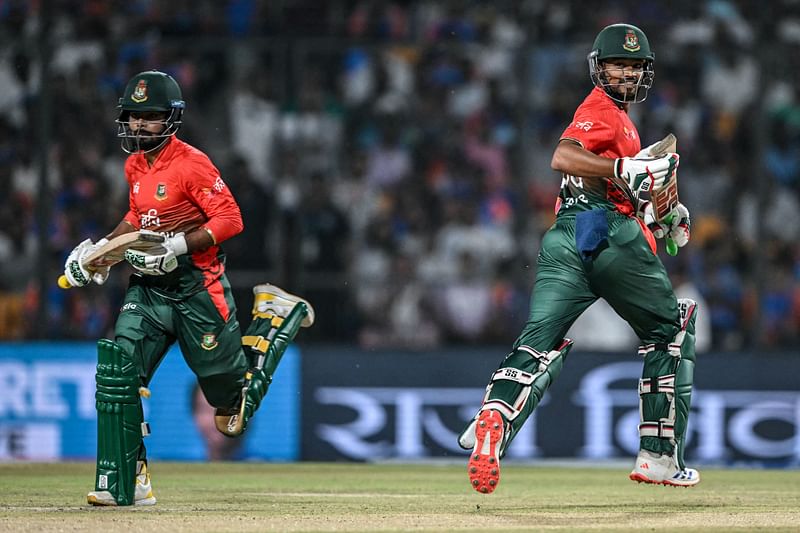 Bangladesh’s captain Najmul Hossain Shanto and his teammate Towhid Hridoy (L) run between the wickets during the first Twenty20 cricket match between India and Bangladesh at the Shrimant Madhavrao Scindia Cricket Stadium in Gwalior on 6 October 2024