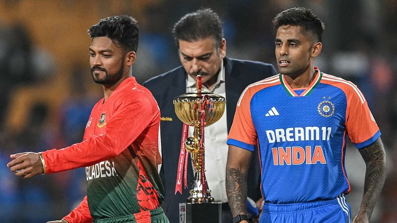 India’s captain Suryakumar Yadav (R) and his Bangladesh’s counterpart Najmul Hossain Shanto (L) gesture during toss before the start of the first Twenty20 cricket match between India and Bangladesh at the Shrimant Madhavrao Scindia Cricket Stadium in Gwalior on 6 October 2024