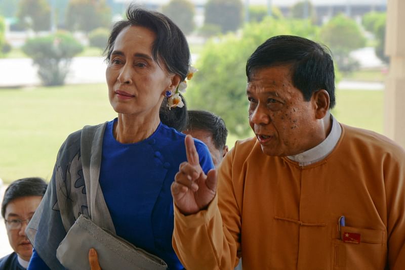 Myanmar's National League for Democracy (NLD) senior leader and lawmaker Zaw Myint Maung (R) escorts Myanmar democracy leader Aung San Suu Kyi during her arrival at the parliament in Naypyidaw on 1 March 2016.