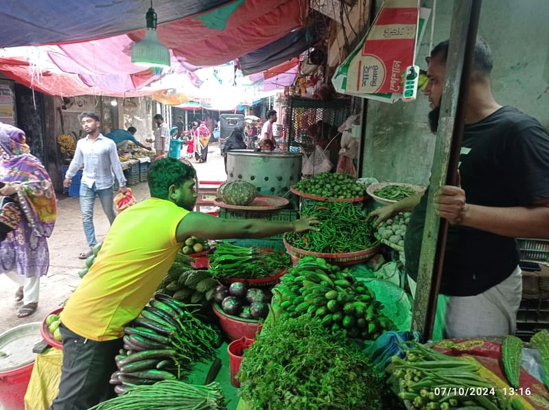 A customer purchases green chillies at a vegetable shop in the Uapzila Sadar Bazar of Matlab South upazila in Chandpur on 7 October 2024.