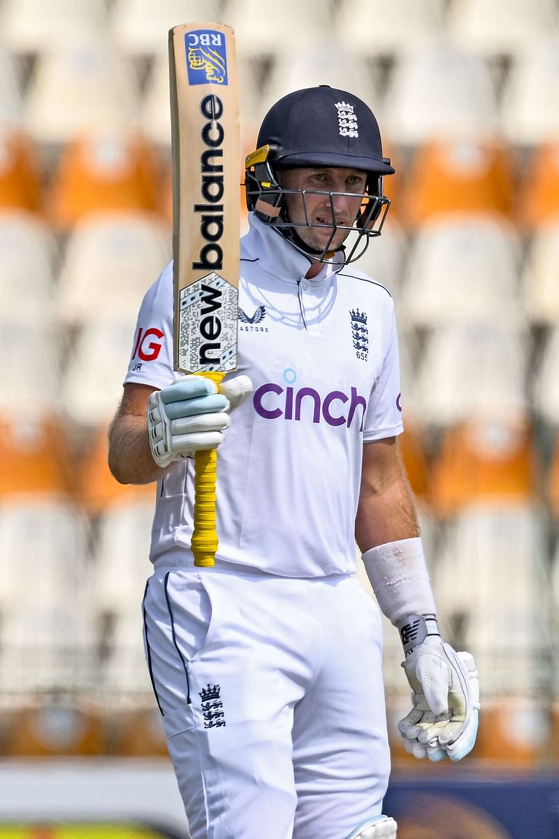 England's Joe Root celebrates after scoring a half-century (50 runs) during the third day of the first Test cricket match between Pakistan and England at the Multan Cricket Stadium in Multan on 9 October 2024.