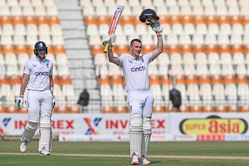 England's Harry Brook (R) celebrates after scoring a triple century (300 runs) as his teammate Jamie Smith watches during the fourth day of the first Test cricket match between Pakistan and England at the Multan Cricket Stadium in Multan on October 10, 2024