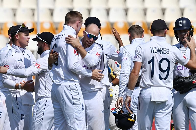 England's players celebrate after winning the first Test cricket match between Pakistan and England at the Multan Cricket Stadium in Multan on 11 October, 2024.