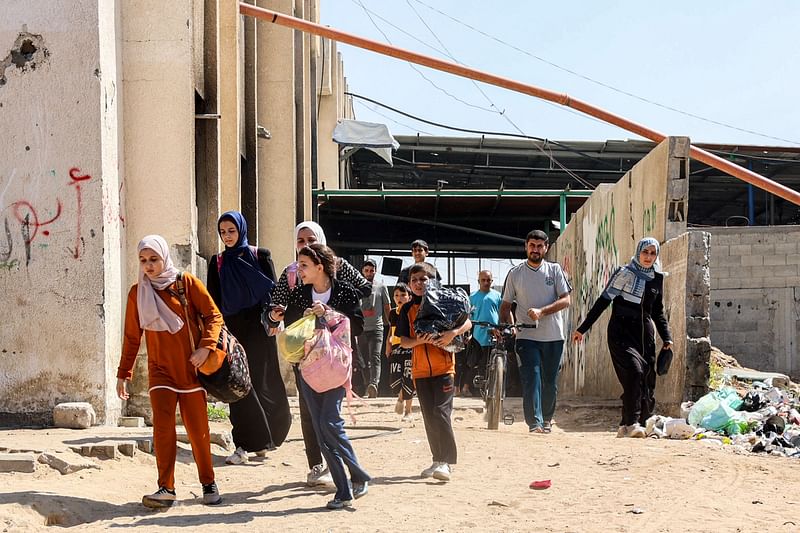 People evacuate from a displacement shelter in the Jabalia camp for Palestinian refugees in the northern Gaza Strip on 9 October, 2024 amid the ongoing war in the Palestinian territory between Israel and Hamas.