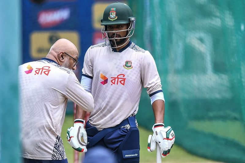 Bangladesh's captain Najmul Hossain Shanto listens to head coach Chandika Hathurusingha during a practice session at Rajiv Gandhi International Cricket Stadium in Hyderabad on 11 October, 2024.