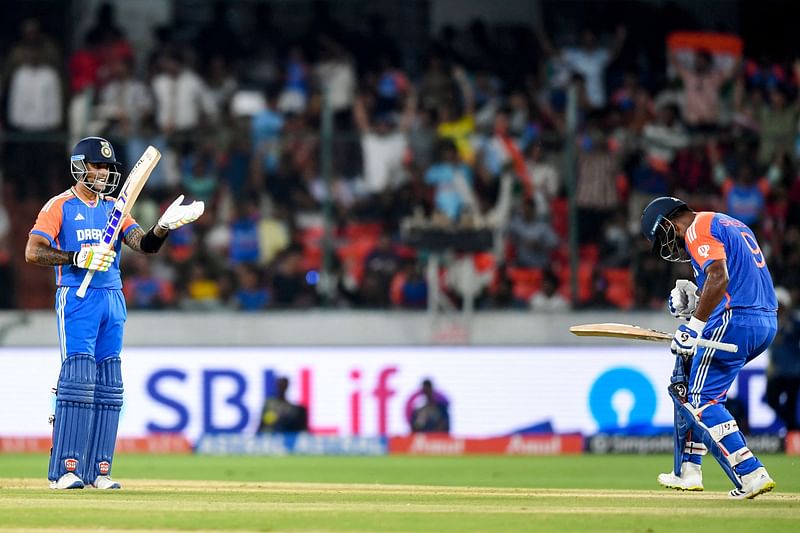 India's Sanju Samson (R) celebrates with captain Suryakumar Yadav after scoring a half-century (50 runs) during the third and final Twenty20 international cricket match between India and Bangladesh at the Rajiv Gandhi International Stadium in Hyderabad on October 12, 2024