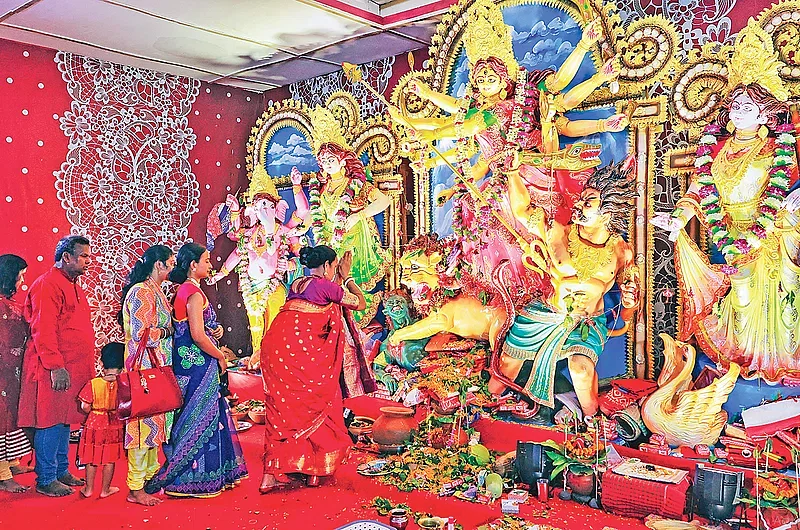 Devotees pray in front of the idol of Goddess Durga at Ramna Kali Temple in the capital on the day of Maha Nabami on 12 October 2024.