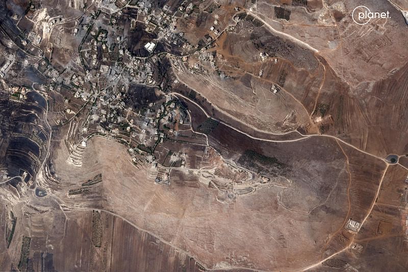 This handout satellite picture provided by Planet Labs PBC and dated on 5 October, 2024, shows Lebanon's southern Maroun El Ras village near the border with Israel, and a UNIFIL peacekeeper's base (bottom R) with military vehicles in its vicinity amid the ongoing war between Israel and Hezbollah fighters.