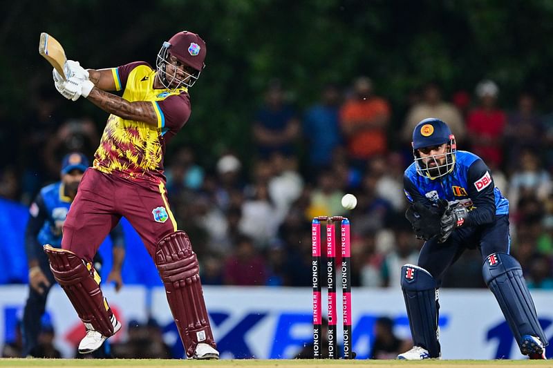 West Indies' Evin Lewis (L) plays a shot during the first Twenty20 international cricket match between Sri Lanka and West Indies at the Rangiri Dambulla International Cricket Stadium in Dambulla on October 13, 2024