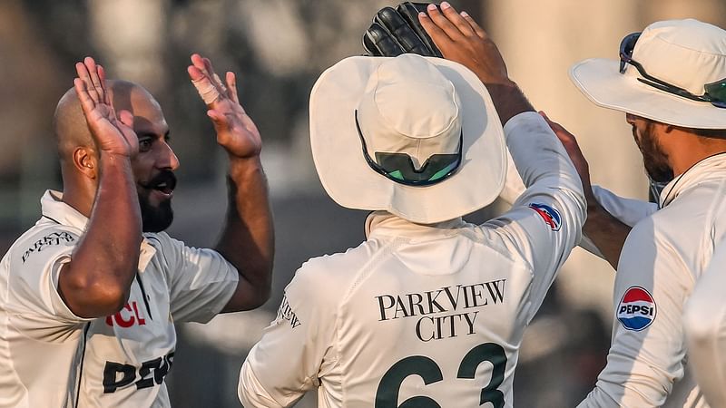 Pakistan's Sajid Khan (L) celebrates with teammates after taking the wicket of England's Harry Brook during the second day of the second Test cricket match between Pakistan and England at the Multan Cricket Stadium in Multan on 16 October, 2024