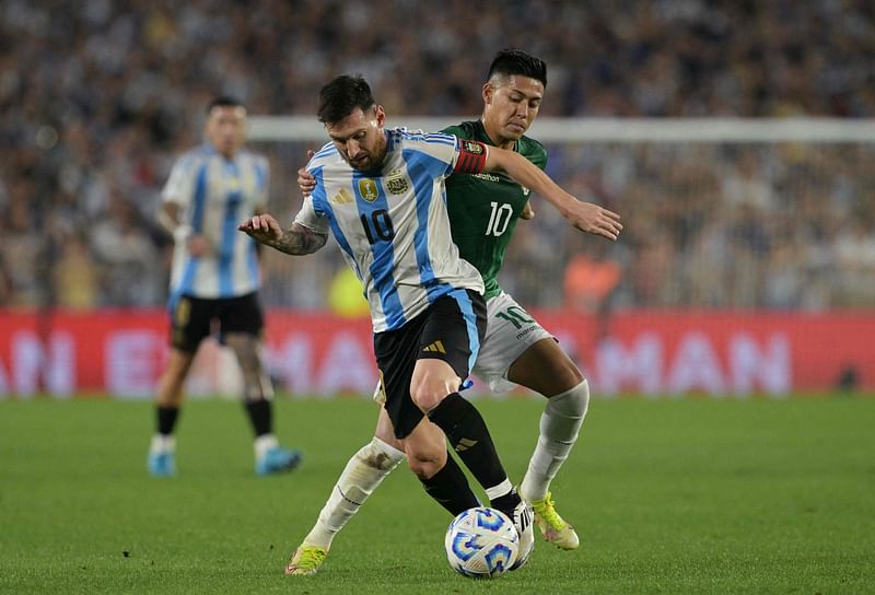 Argentina’s forward #10 Lionel Messi and Bolivia’s forward #10 Ramiro Vaca fight for the ball during the 2026 FIFA World Cup South American qualifiers football match between Argentina and Bolivia at the Mas Monumental stadium in Buenos Aires on 15 October 2024