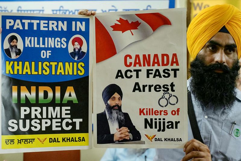 A member of a Sikh organisation holds a placard displaying Sikh separatist Hardeep Singh Nijjar in Amritsar on September 22, 2023.