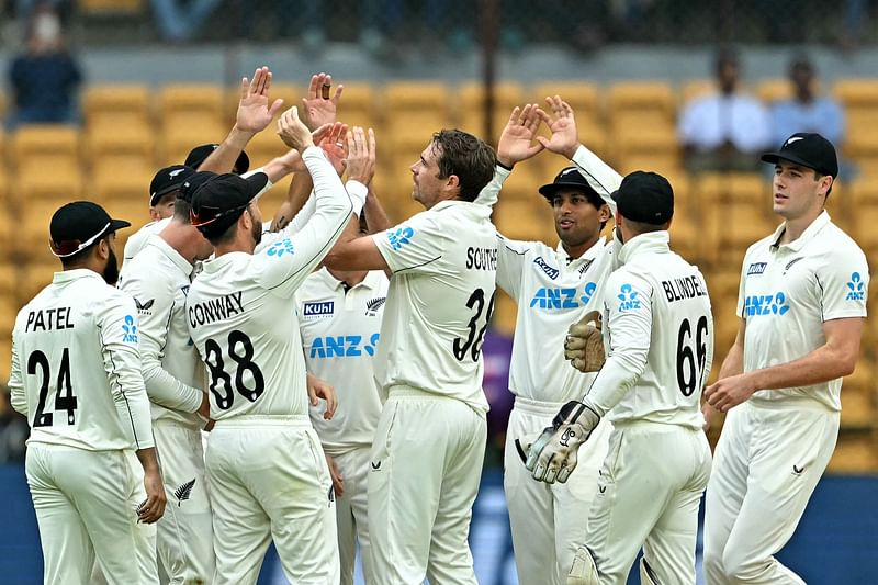 New Zealand’s players celebrate after the dismissal of India’s captain Rohit Sharma during the second day of the first Test cricket match between India and New Zealand at the M. Chinnaswamy Stadium in Bengaluru on 17 October 2024