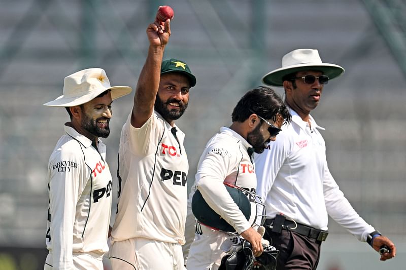 Pakistan's Sajid Khan (2L) with teammates walk back at the end of first innings of the third day of second Test cricket match between Pakistan and England at the Multan Cricket Stadium in Multan on 17 October, 2024