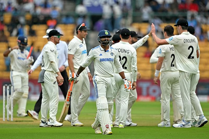 New Zealand’s players celebrate after the dismissal of India’s Ravindra Jadeja (C) during the second day of the first Test cricket match between India and New Zealand at the M. Chinnaswamy Stadium in Bengaluru on 17 October 2024