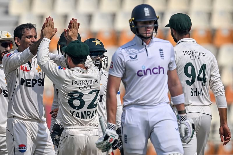 Pakistan's Noman Ali (2L) celebrates with teammates after taking the wicket of England's Jamie Smith during the fourth day of the second Test cricket match between Pakistan and England at the Multan Cricket Stadium in Multan on 18 October, 2024.