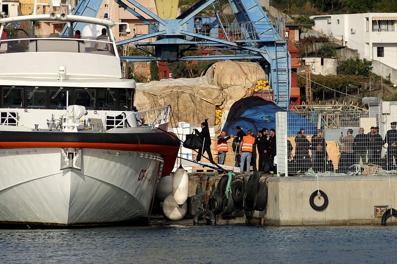 A group of migrants embark on an Italian coast guard ship at Shengjin port in Albania on 19 October 2024.