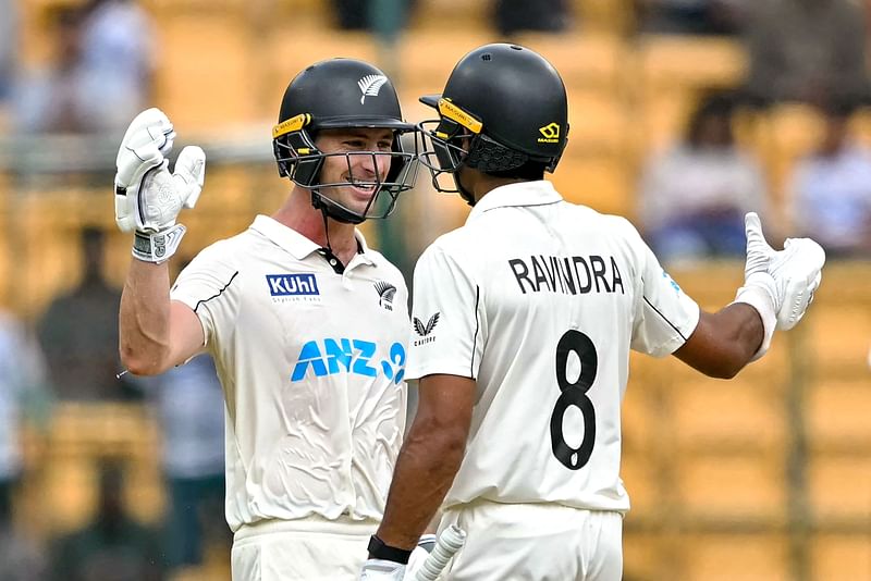 New Zealand's Will Young (L) and Rachin Ravindra celebrate their team's win against India at the end of their first Test cricket match in the M. Chinnaswamy Stadium of Bengaluru on 20 October 2024.