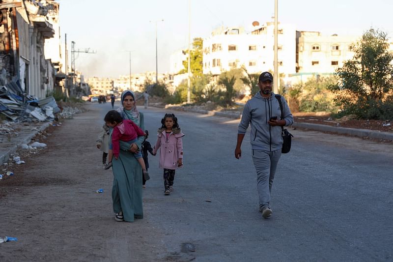 Displaced Palestinians, ordered by the Israeli army to leave the school in Beit Lahia where they were sheltered, arrive in Gaza City on 19 October, 2024.