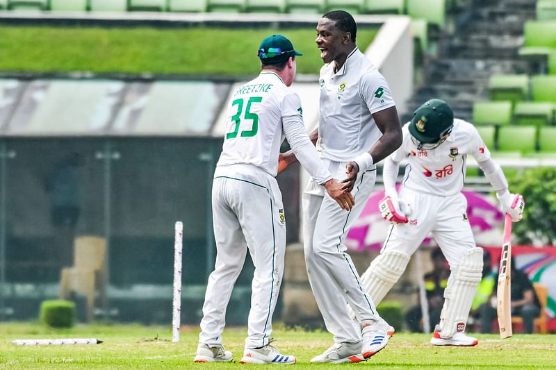 South Africa's Kagiso Rabada (C) celebrates with teammate after taking the wicket of Bangladesh's Mushfiqur Rahim (R) during the first day of the first Test cricket match between Bangladesh and South Africa at the Sher-e-Bangla National Cricket Stadium in Dhaka on October 21, 2024.