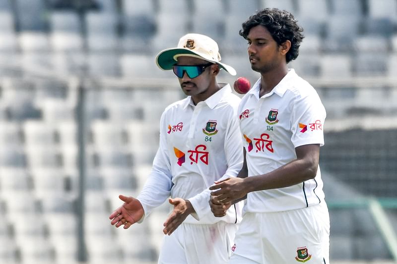 Bangladesh's captain Najmul Hossain Shanto (L) and Hasan Mahmud speak during the second day of the first Test cricket match between Bangladesh and South Africa at the Sher-e-Bangla National Cricket Stadium in Dhaka on October 22, 2024