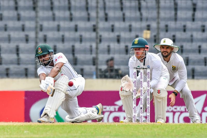 Bangladesh's Mehidy Hasan Miraz (L) plays a shot during the third day of the first Test cricket match between Bangladesh and South Africa at the Sher-e-Bangla National Cricket Stadium in Dhaka on October 23, 2024