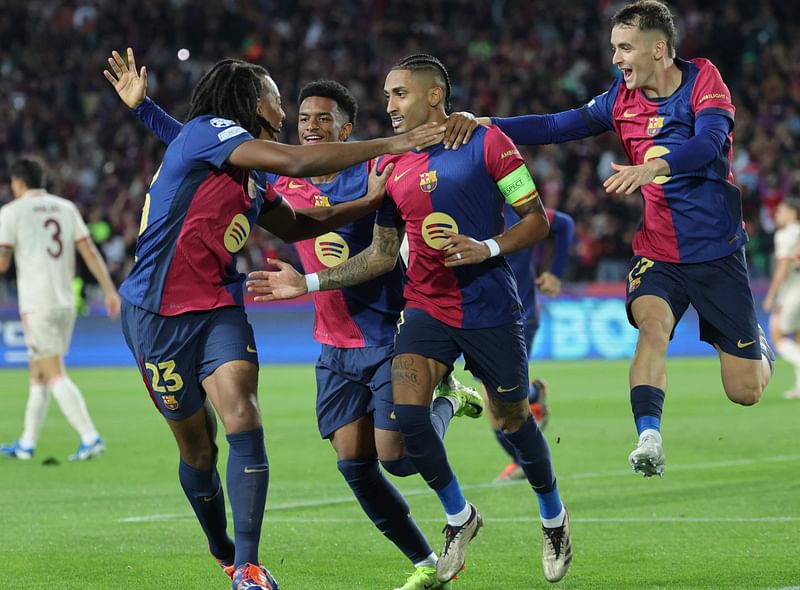 Barcelona's Brazilian forward #11 Raphinha (2R) celebrates scoring the opening goal, during the UEFA Champions League, league phase day 3 football match between FC Barcelona and FC Bayern Munich at the Estadi Olimpic Lluis Companys in Barcelona on 23 October, 2024