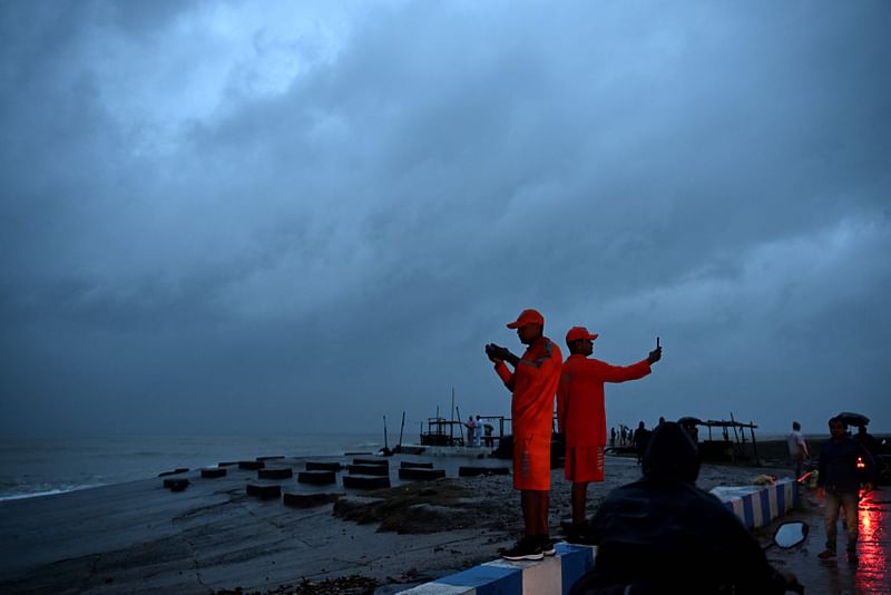 National Disaster Response Force (NDRF) personnel stand guard ashore, at a beach near Digha on 24 October, 2024.