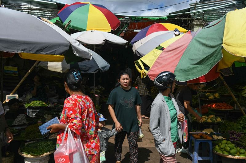 People walk through a market in Pyin Oo Lwin in Myanmar's Mandalay region on 24 October, 2024.