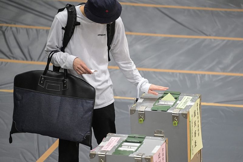 A man votes during the general election at a polling station set up at a local school in Tokyo on October 27, 2024. Japan voted on October 27 in its tightest election in years, with new Prime Minister Shigeru Ishiba and his juggernaut Liberal Democratic Party facing potentially their worst result since 2009