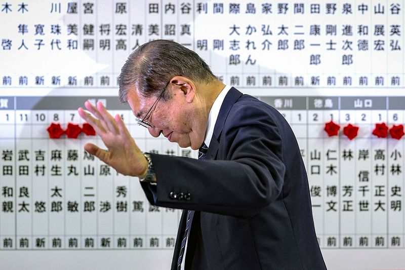 Japan's Prime Minister Shigeru Ishiba waves as he leaves after addressing the media at the Liberal Democratic Party (LDP) headquarters in Tokyo on October 27, 2024