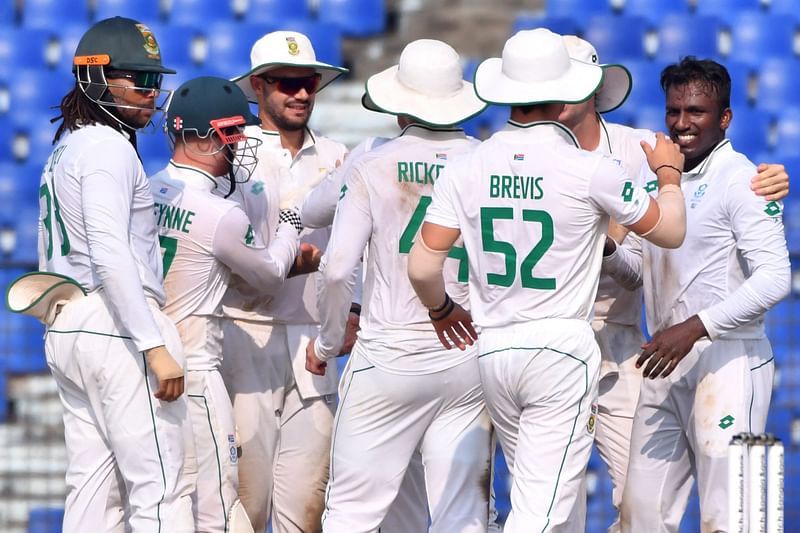 South Africa’s Senuran Muthusamy celebrates with teammates after the dismissal of Bangladesh’s Mahmudul Hasan Joy during the third day of the second Test cricket match between Bangladesh and South Africa at the Zahur Ahmed Chowdhury Stadium in Chittagong on 31 October, 2024.