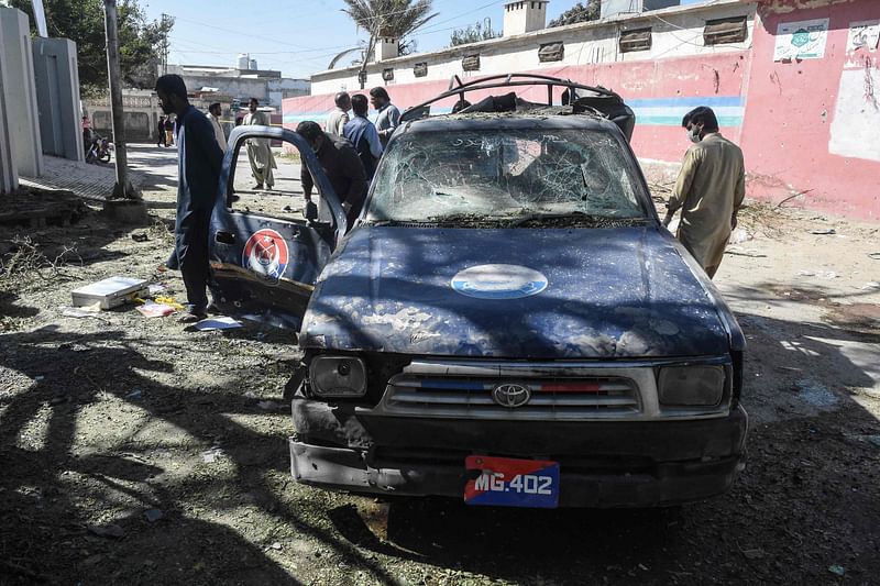 Security personnel inspect the blast site near a girls' school targeting police guarding polio vaccinators in the city of Mastung in Balochistan province on 1 November, 2024.