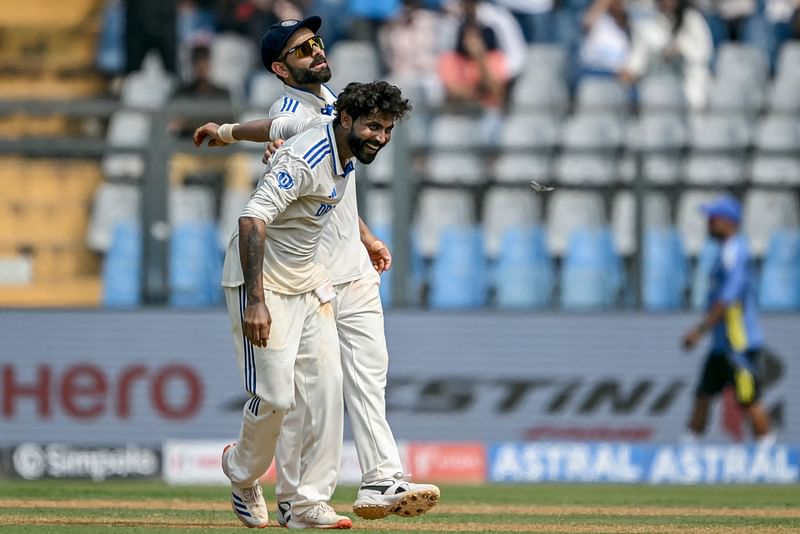 India’s Ravindra Jadeja (front) celebrates with teammate Virat Kohli after taking the wicket of New Zealand’s Will Young during the first day of the third Test cricket match between India and New Zealand at the Wankhede Stadium in Mumbai on 1 November 2024